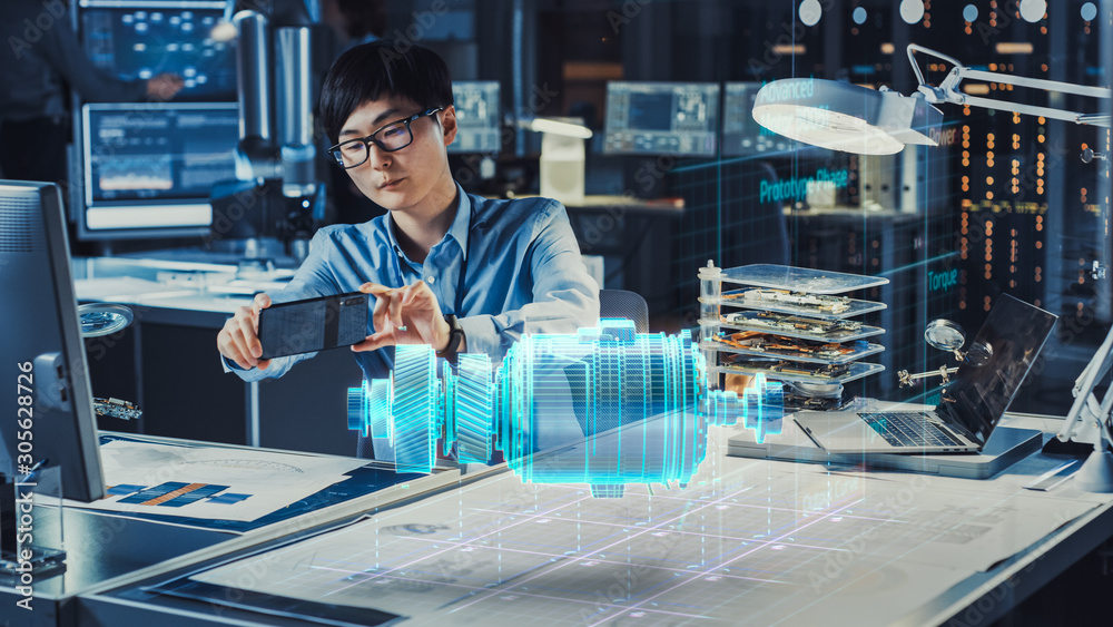 Aufkleber Industrial Engineer Works with Smartphone Using Augmented Reality Holographic Projection 3D Model of the Enlectric Motor Prototype. Development of Virtual Mixed Reality Application.