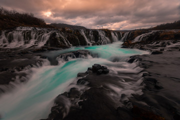 Fototapeta na wymiar Bruarfoss turquoise waterfall next to Brekkuskógur at South Iceland. 