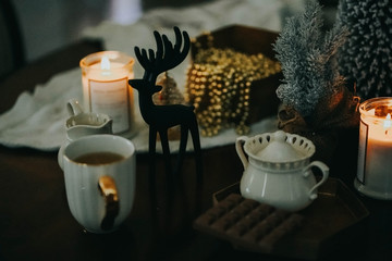  new year flatlay. holiday decorations. Christmas sill life card. Low key picture. Cozy house. candle and a cup of tea. 