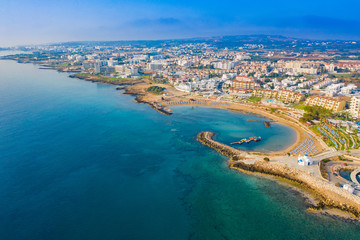 Naklejka na ściany i meble Cyprus. Protaras aerial view. Church of St. Nicholas with a quadcopter. White Church in Cyprus. Panorama of the city of Protaras. The beaches of Cyprus. Port Paralimni. Mediterranean Sea