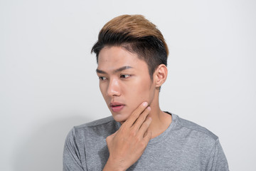 Close up of Asian man portrait touching his neck on white background