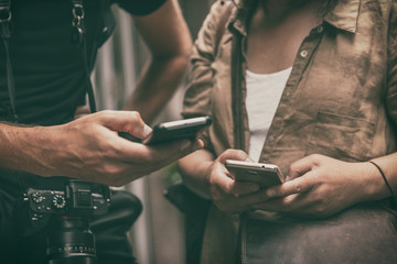 People using mobile phones holding smartphones travel lifestyle. Closeup of hands texting on smart cellphone tech devices tourists woman and man lost searching for directions.