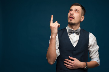 Doubting handsome young man in formal clothes