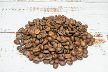 Organic coffee beans on white wooden table