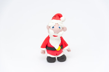 Santa Claus figurine. Toy Santa on white background. Christmas and New Year holidays concept. Closeup