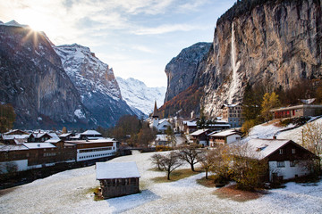 amazing touristic alpine village in winter with famous church and Staubbach waterfall  Lauterbrunnen  Switzerland  Europe
