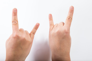 two hands with goat gesture