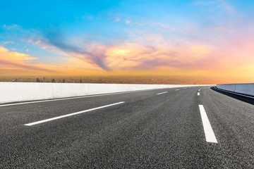 Fototapeta premium Shanghai city skyline and empty asphalt road scenery at sunset.