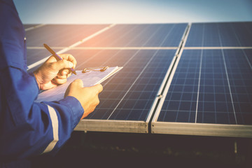 operation and maintenance in solar power plant ; engineering team working on checking and maintenance in solar power plant ,solar power plant to innovation of green energy for life