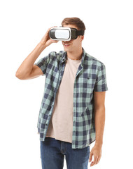 Young man with virtual reality glasses on white background