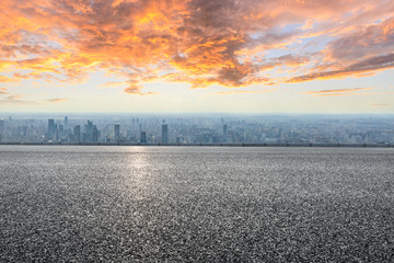 Shanghai city skyline and empty asphalt road scenery at sunset.