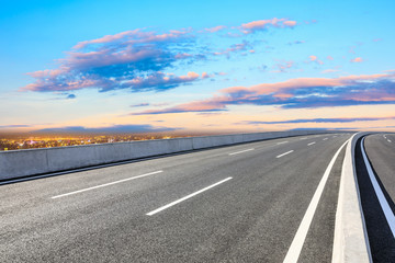 Naklejka premium Shanghai city skyline and empty asphalt road scenery at sunset.