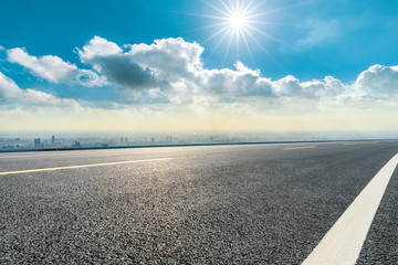 Asphalt highway and city skyline with clouds scenery in Shanghai.