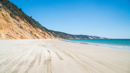 cliffs meeting the golden beach