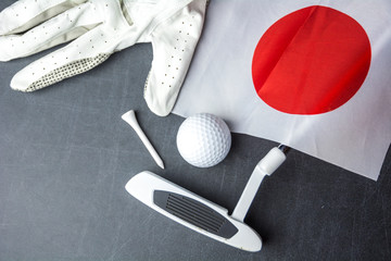 Golf ball with flag of Japan on wood table