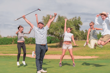 A group celebrating on a golf course