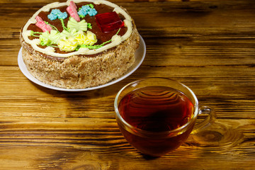Cup of tea and Kiev cake on a wooden table