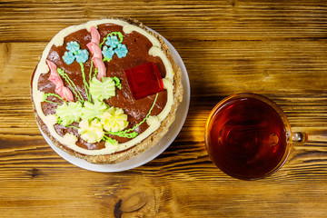 Cup of tea and Kiev cake on a wooden table. Top view