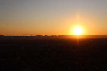 Fototapeta premium Sun Setting Behind a Mountain 