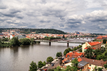 Fototapeta na wymiar Aerial view of Praha (Prague), Czech. Prague is colorful and beautiful European city.Beautiful view of the architecture of Prague and bridge over river Vltava in the Czech. Dramatic sky background.