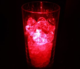Red glowing cocktail glass with glass blocks