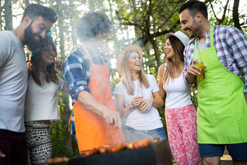 Small group of friends having fun at barbecue party