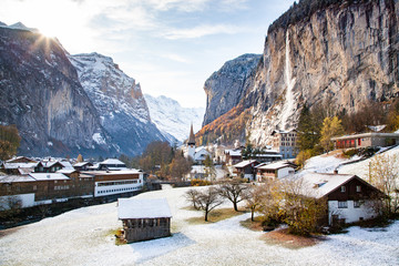 amazing touristic alpine village in winter with famous church and Staubbach waterfall ...