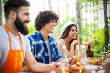 Small group of friends having fun at barbecue party