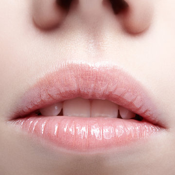 Closeup shot of human female face. Woman with pink plump lips makeup