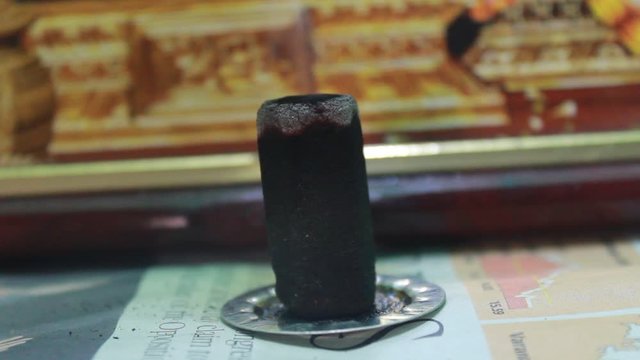 Close up shot of full burned dhoop batti / incense stick with some smoke on the pooja room