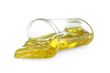 Overturned plastic container with yellow slime isolated on white. Antistress toy