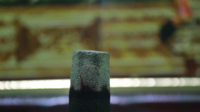 Close up shot of full burned dhoop batti / incense stick with some smoke on the pooja room
