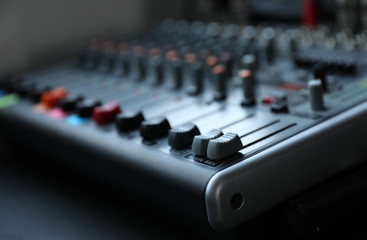 Modern audio mixing console, closeup. Music equipment