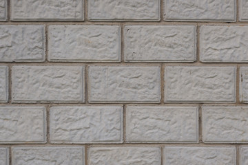 Wall of a house made of gray concrete blocks. Dark background or wallpaper. Low contrast picture. Construction and repair of buildings