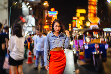 Obraz na płótnie Canvas Young Asian fashion stylish traveler woman standing outdoor on street joy city nightlife in China town, Tourist girl travel Bangkok city Thailand, Tourism beautiful destination Asia holiday vacation