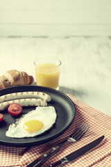 Fried sausage with eggs and vegetables