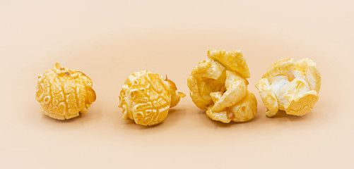 Delicious popcorn with caramel on color background