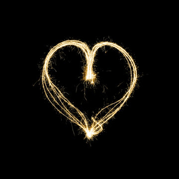 heart shape light painting with sparklers isolated on black background - symbol for love and romance