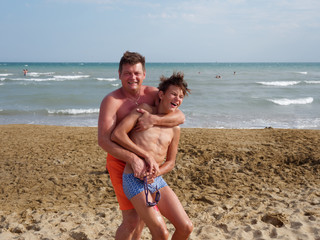 Father with son at the beach in Bibione, Italy