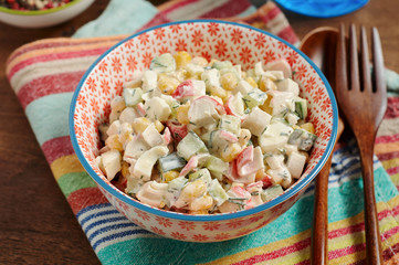 Bowl of Surimi Seafood Salad with sweet corn, cucumbers, boiled eggs and mayonnaise
