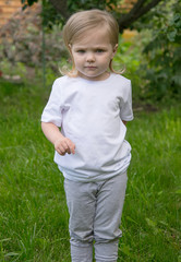 three-year-old girl in a white t-shirt in the garden mock-up
