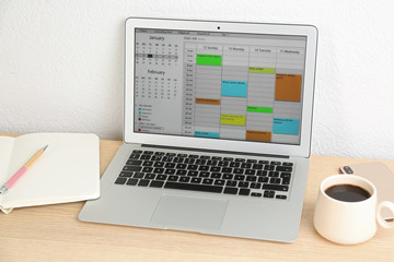 Fototapeta premium Modern laptop with calendar app in office