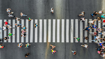 Aerial. Pedestrians on a zebra crosswalk. Top view. - obrazy, fototapety, plakaty