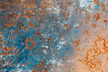 Old peeling cracked blue paint on the surface of a rusty corroded metal sheet. Beautiful, trendy,...
