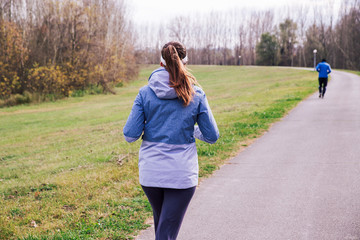 Back view of a female jogger outdoors in cold weather © eshana_blue