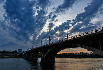 Fototapeta na wymiar Bridge over Angara river in Irkutsk city after sunset wtih blue clouds