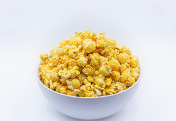 Delicious popcorn with caramel in bowl on.white color background