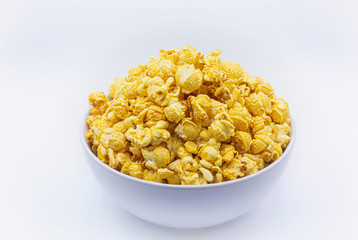Delicious popcorn with caramel in bowl on.white color background