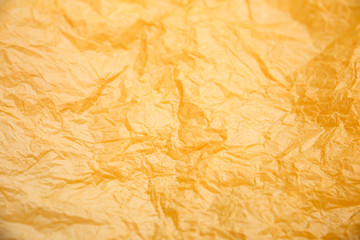 Rumpled yellow background. Real texture of the wrapping texture.