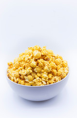 Delicious popcorn with caramel in bowl on.white color background